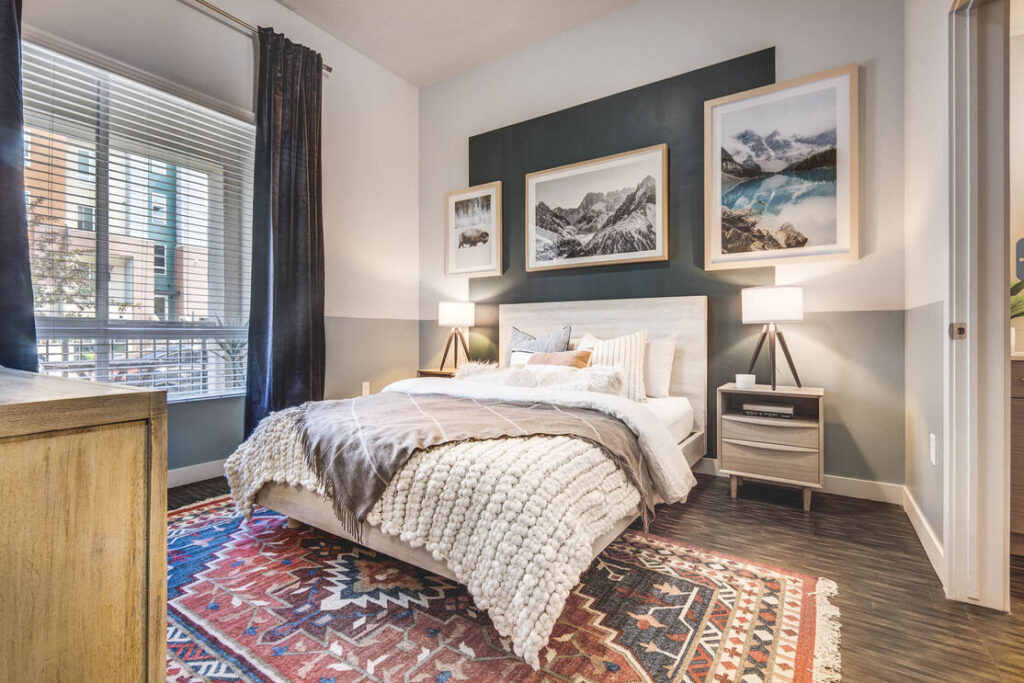 view of bedroom and huge window for natural lighting and neutral color decor