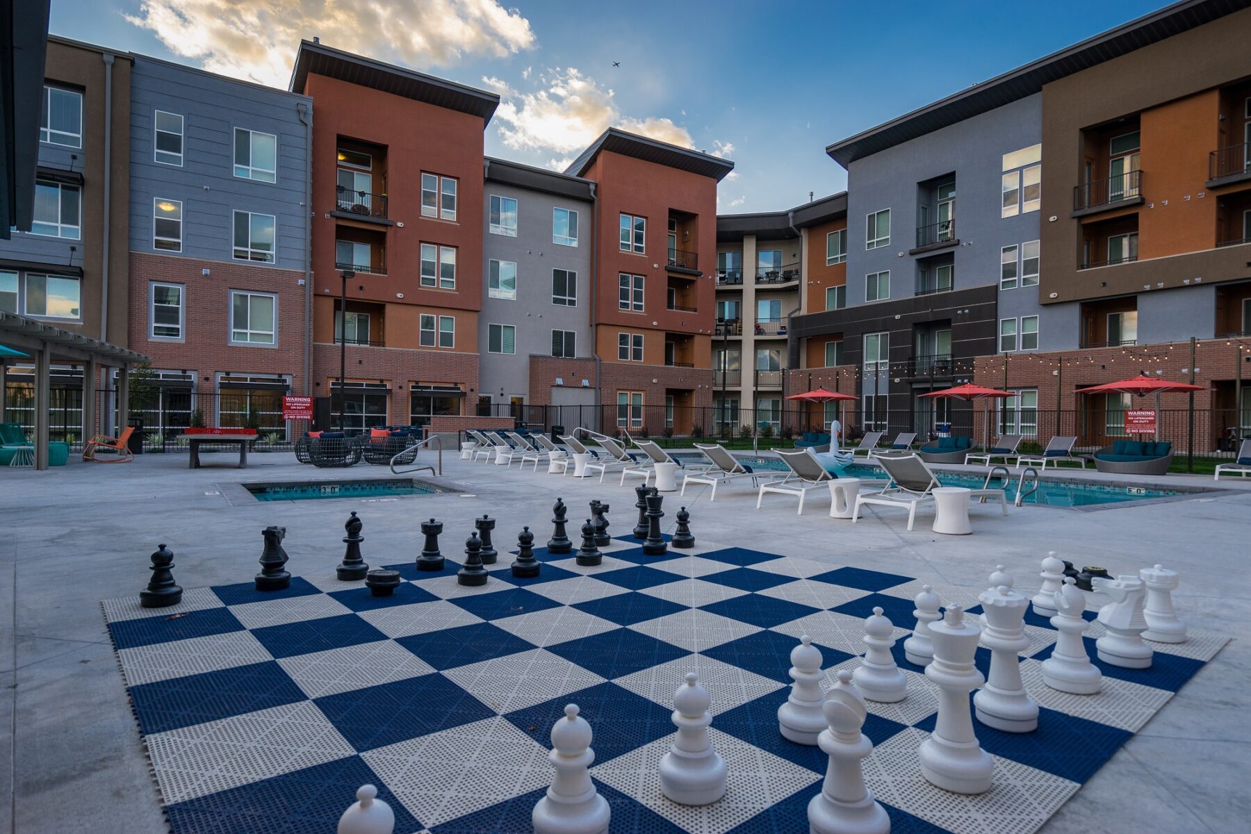 view of pool area and huge chess board as well as poolside seating