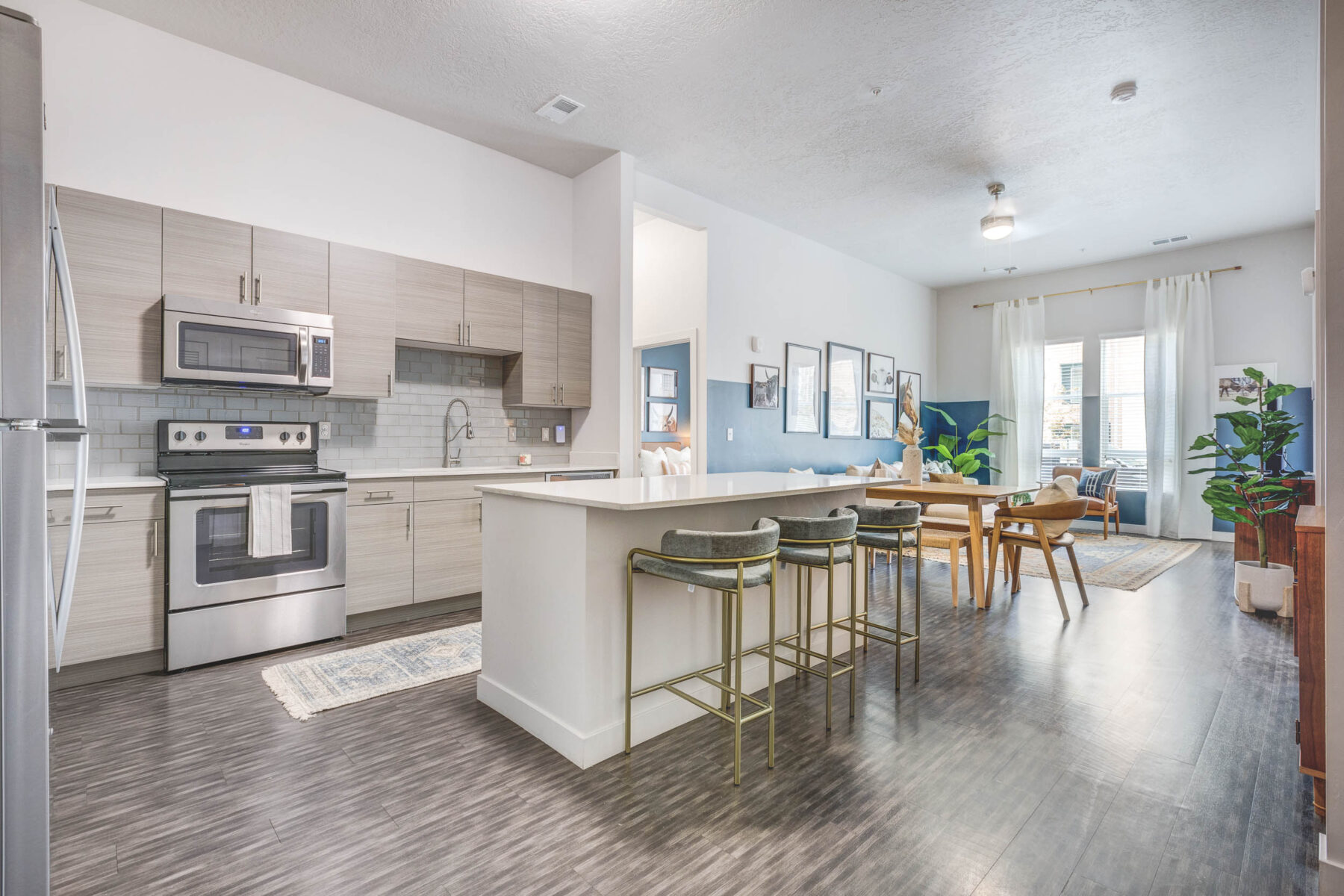 kitchen area with bar, and view of living room space and grey kitchen decor