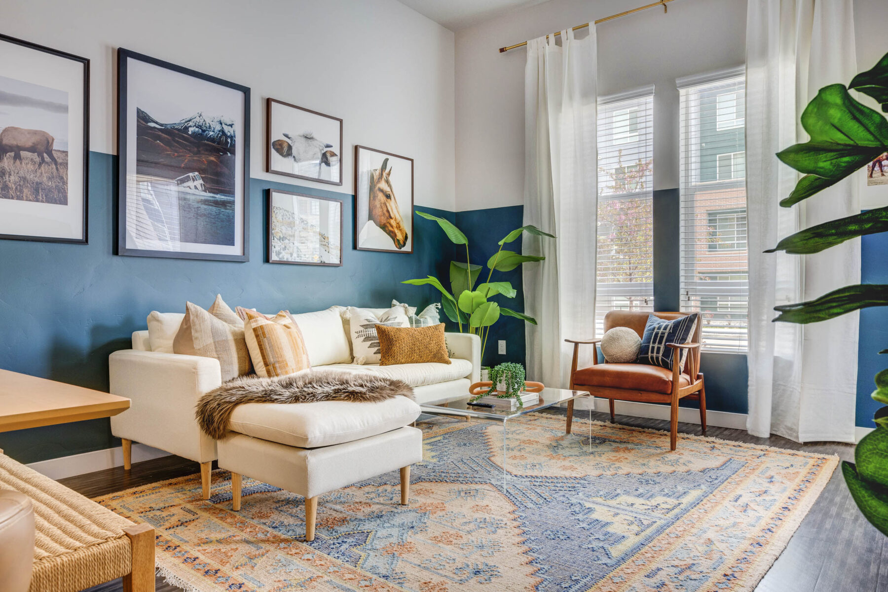 living room with white couch and large window and neutral color decor