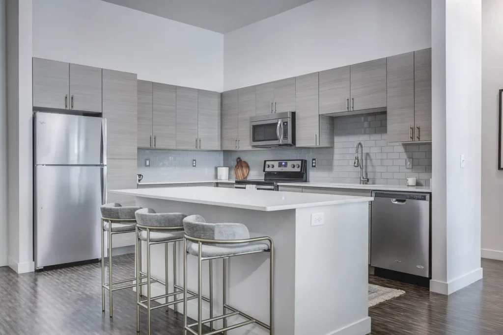 grey kitchen view of island countertop and simple grey cabinets and backsplash