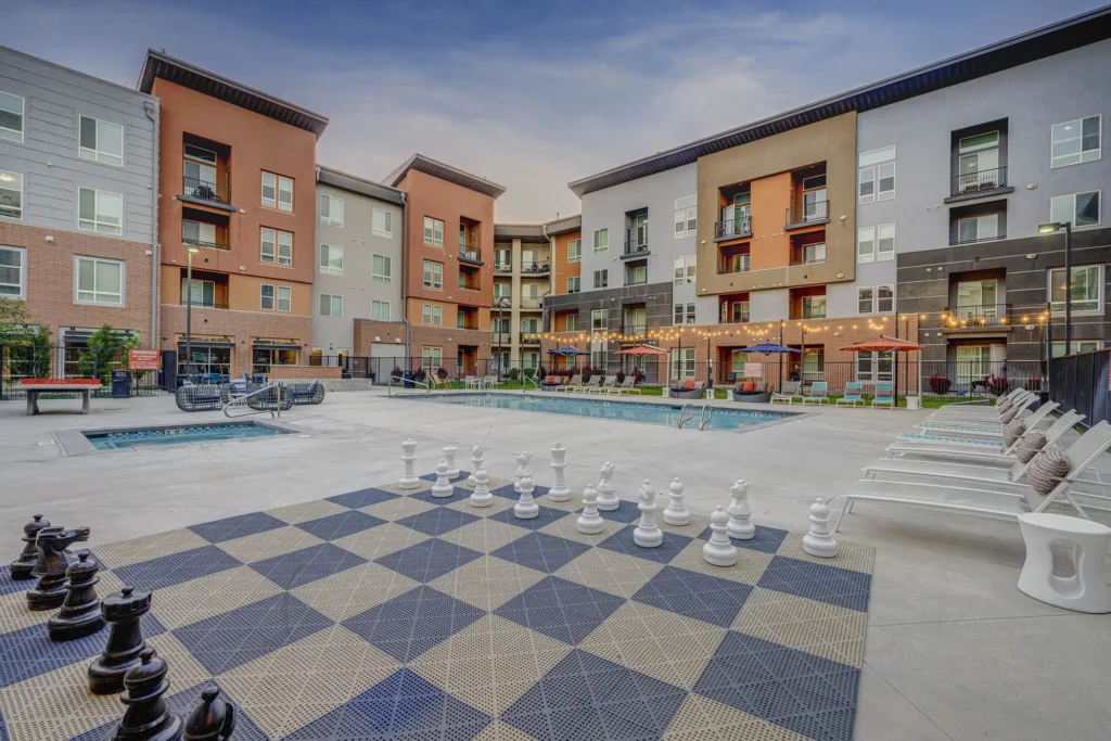 view of pool area and huge chess board as well as poolside seating
