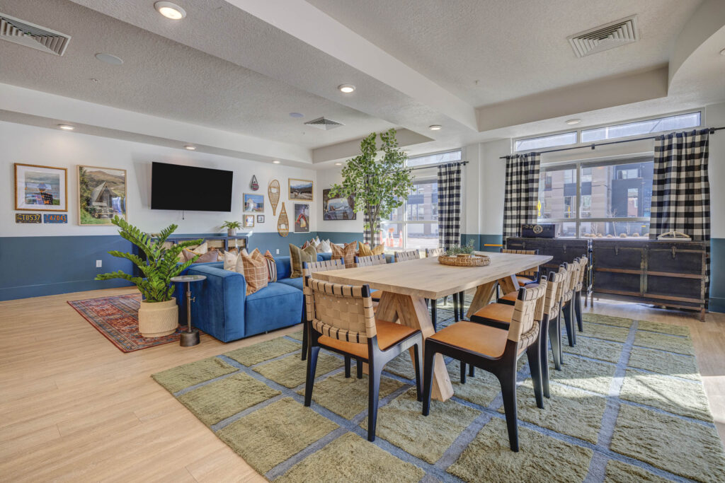 Clubhouse lounge with sofas, tables, and TV